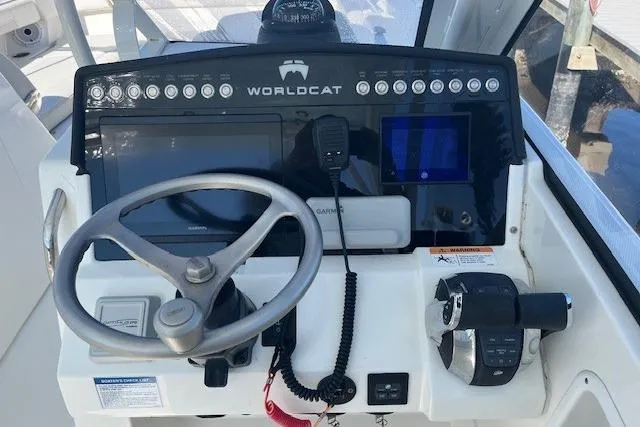 Slide: The Image of 2024 World Cat 280 DC-X helm with steering wheel, controls, and navigation equipment. - 5