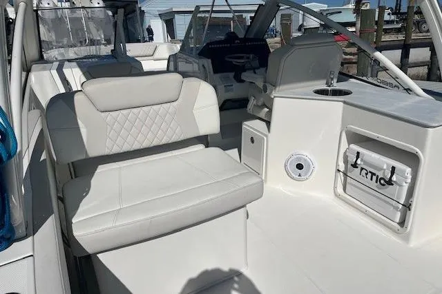 Slide: The Image of 2024 World Cat 280 DC-X boat interior with white seating and modern design. - 8