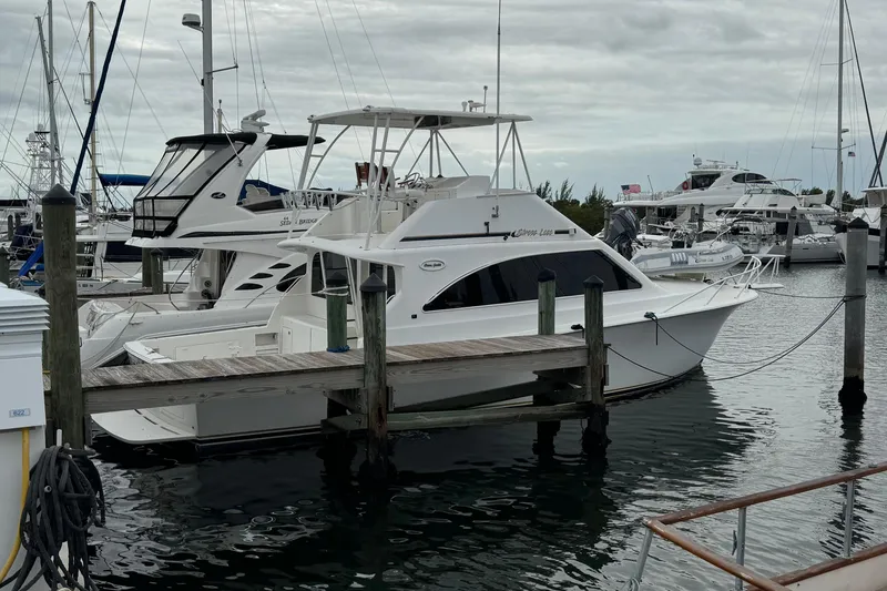 The Image of 1997 Ocean Yachts 40 Super Sport docked at a marina with other boats. - 0