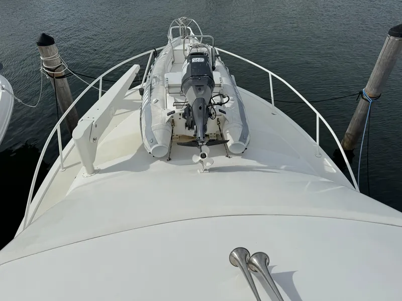 Slide: The Image of 1997 Ocean Yachts 40 Super Sport bow with dinghy and outboard motor. - 10