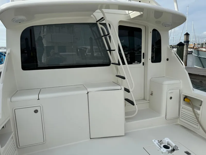 Slide: The Image of 1997 Ocean Yachts 40 Super Sport boat deck with storage compartments and ladder. - 12