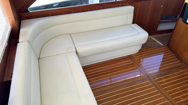 Slide: The Image of Interior of 1997 Ocean Yachts 40 Super Sport with white leather seating and wooden flooring. - 17