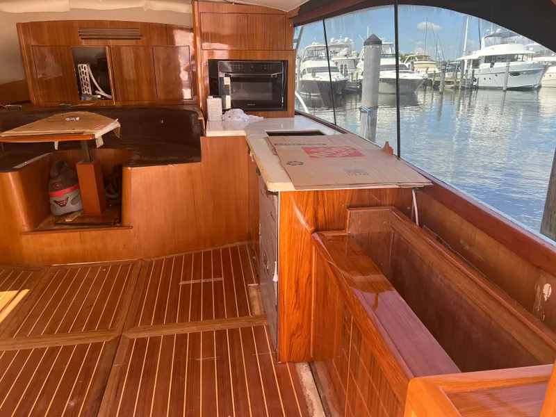 Slide: The Image of Interior of a 1997 Ocean Yachts 40 Super Sport with wooden flooring and marina view. - 23