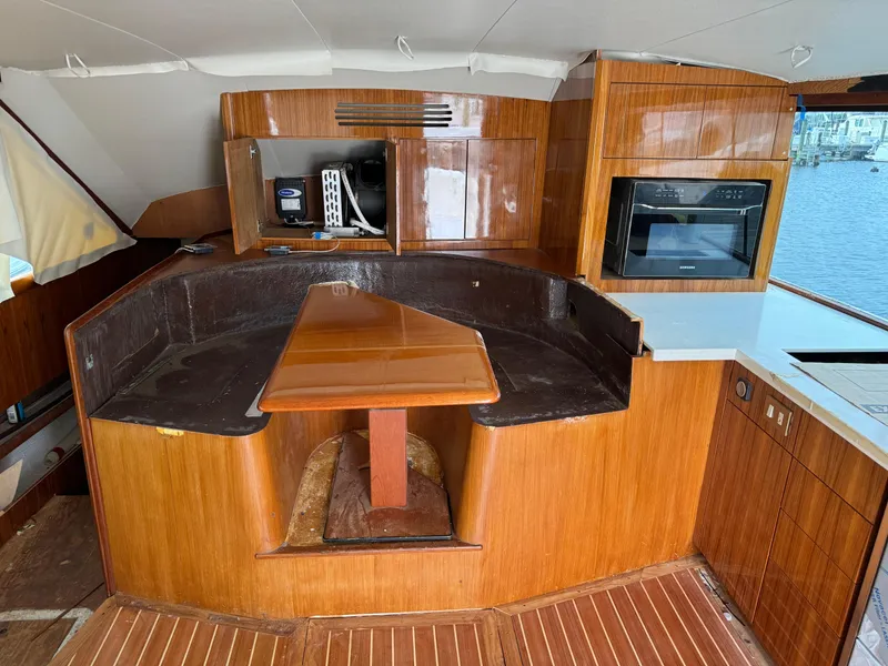 Slide: The Image of Interior of 1997 Ocean Yachts 40 Super Sport with wooden cabinetry and dining area. - 28