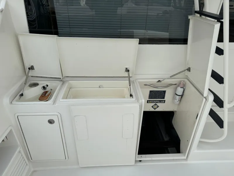 Slide: The Image of 1997 Ocean Yachts 40 Super Sport yacht deck with storage compartments and sink. - 6