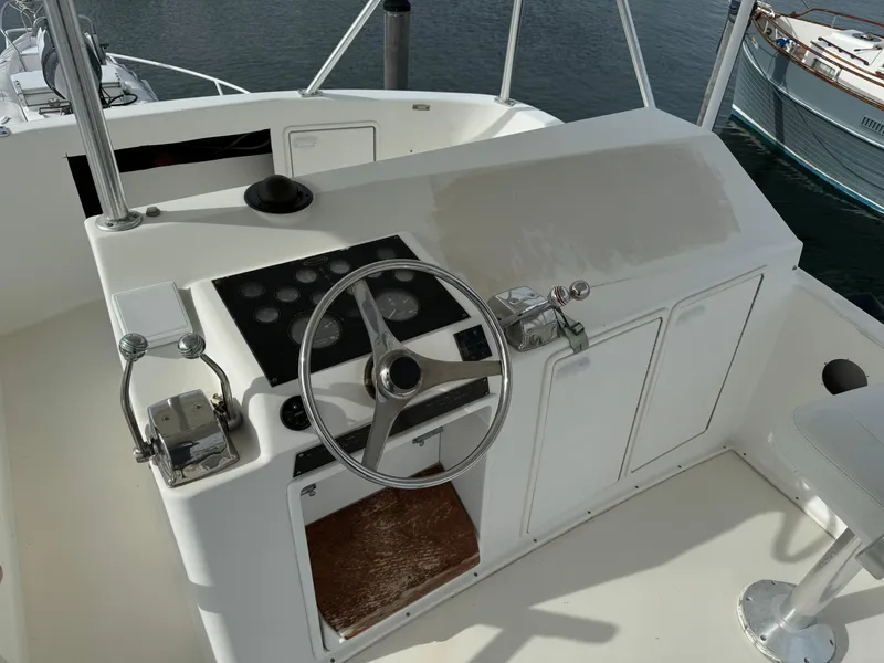 Slide: The Image of 1997 Ocean Yachts 40 Super Sport helm station with steering wheel and controls. - 7