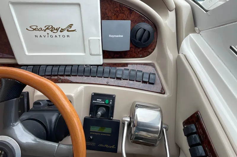 Slide: The Image of Control panel of a 2002 Sea Ray 480 Motor Yacht with wooden steering wheel. - 10