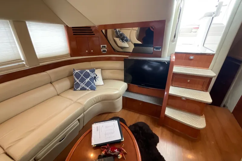 Slide: The Image of Interior of 2002 Sea Ray 480 Motor Yacht with leather seating and TV. - 12