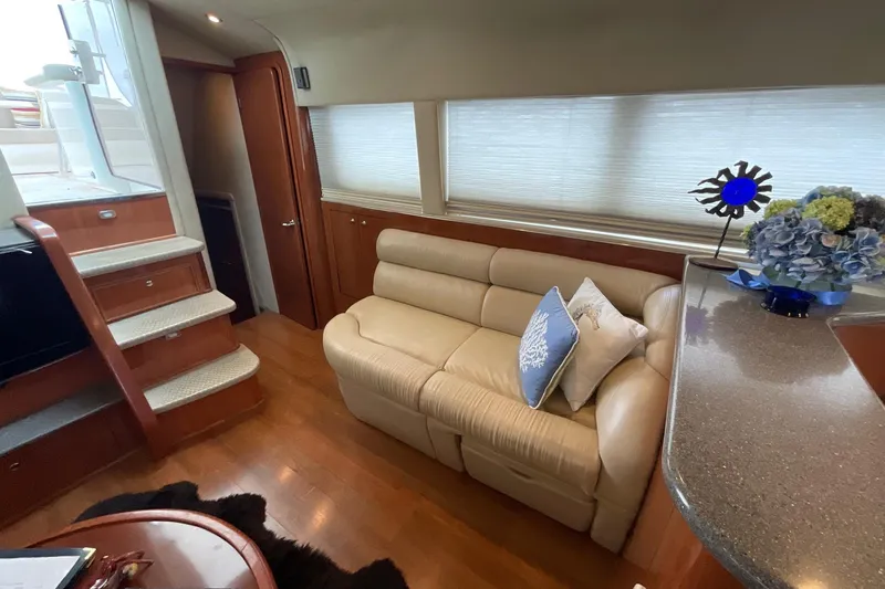 Slide: The Image of Luxurious interior of 2002 Sea Ray 480 Motor Yacht with beige sofa and elegant decor. - 15