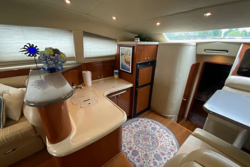 Slide: The Image of Luxurious 2002 Sea Ray 480 Motor Yacht interior with elegant kitchen and cozy seating area. - 21