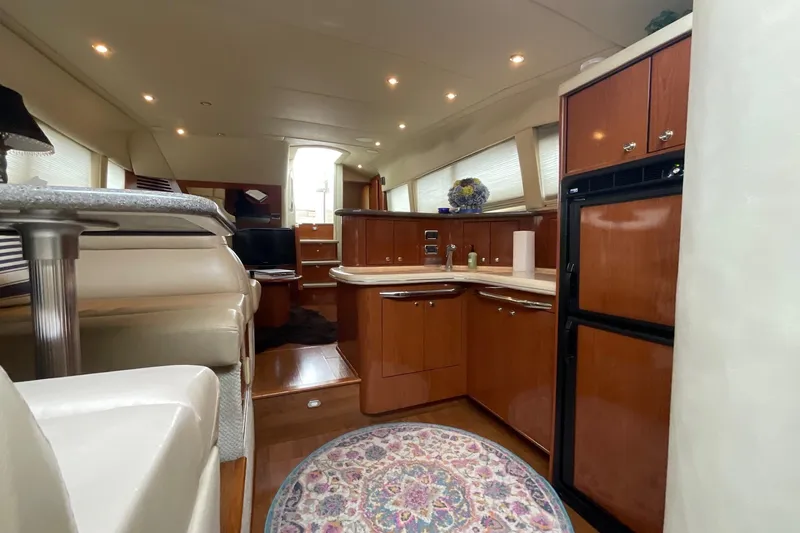 Slide: The Image of Luxurious interior of 2002 Sea Ray 480 Motor Yacht with elegant wood cabinetry. - 22