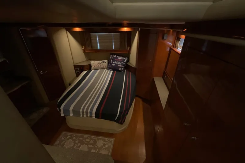 Slide: The Image of Luxurious cabin interior of 2002 Sea Ray 480 Motor Yacht with striped bedding. - 24