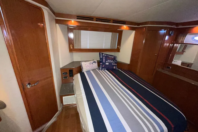 Slide: The Image of Luxurious cabin interior of 2002 Sea Ray 480 Motor Yacht with striped bedding. - 25