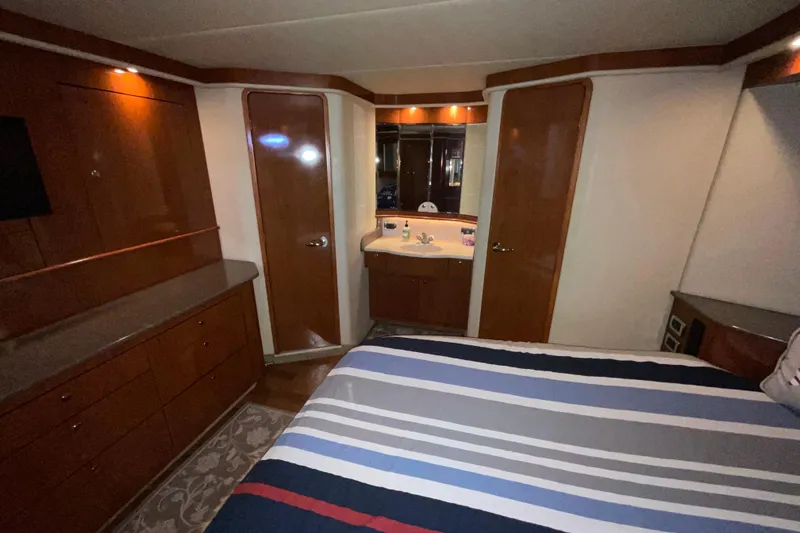 Slide: The Image of Luxurious cabin interior of 2002 Sea Ray 480 Motor Yacht with wood finishes. - 26