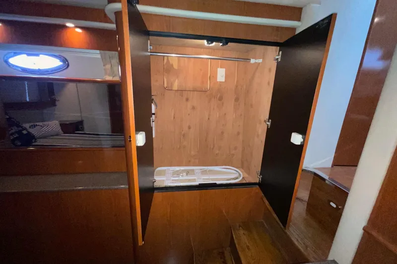 Slide: The Image of Open wooden closet inside 2002 Sea Ray 480 Motor Yacht cabin interior. - 29