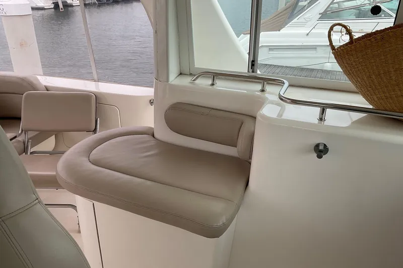 Slide: The Image of Interior of 2002 Sea Ray 480 Motor Yacht with beige seating and window view. - 3