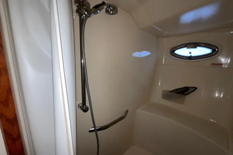 Slide: The Image of Shower area in 2002 Sea Ray 480 Motor Yacht with porthole and chrome fixtures. - 32