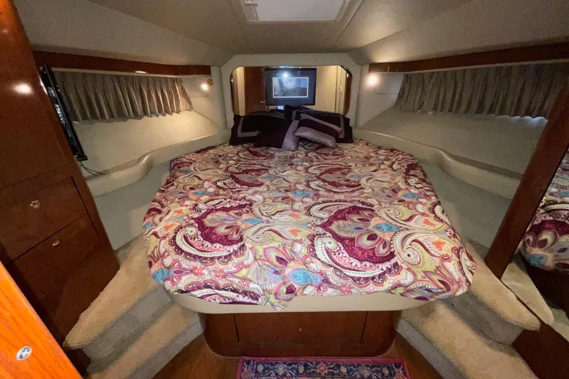 Slide: The Image of Luxurious bedroom interior of 2002 Sea Ray 480 Motor Yacht with patterned bedding. - 36
