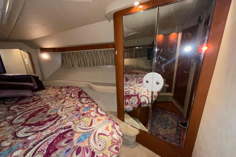 Slide: The Image of Luxurious 2002 Sea Ray 480 Motor Yacht bedroom with mirrored closet and patterned bedding. - 39