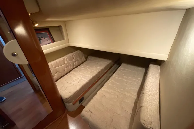 Slide: The Image of 2002 Sea Ray 480 Motor Yacht interior cabin with twin beds and wooden accents. - 41