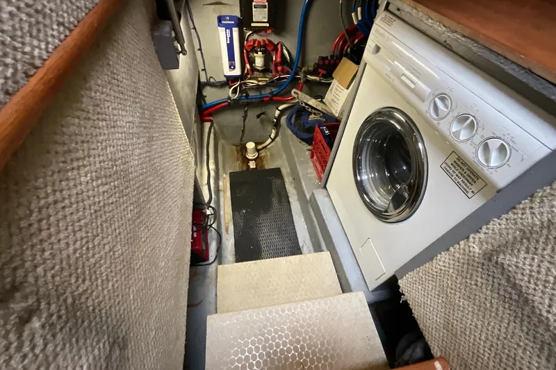 Slide: The Image of Laundry area inside 2002 Sea Ray 480 Motor Yacht, featuring a washing machine. - 46