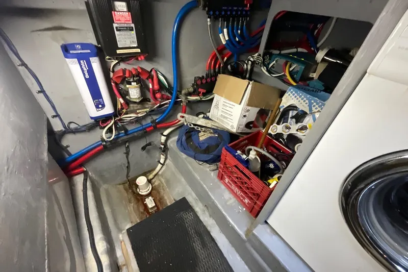 Slide: The Image of 2002 Sea Ray 480 Motor Yacht engine room with wiring, storage, and equipment. - 47