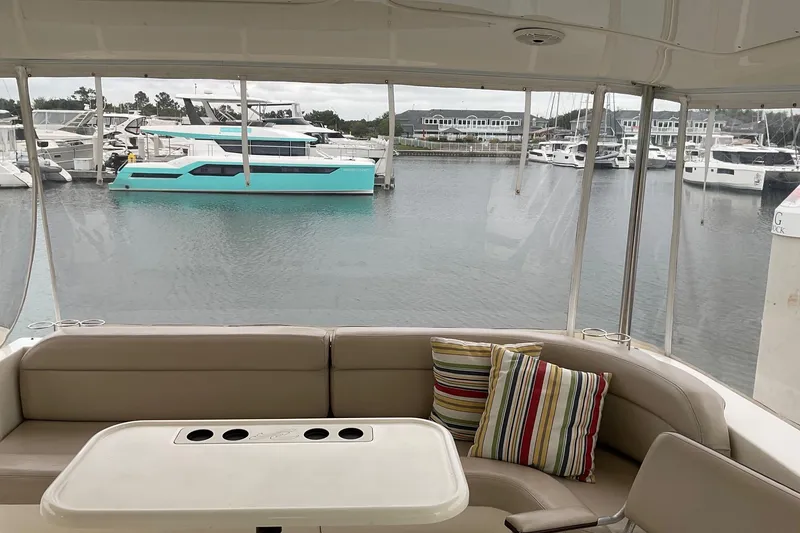 Slide: The Image of Interior view of a 2002 Sea Ray 480 Motor Yacht with marina backdrop. - 6