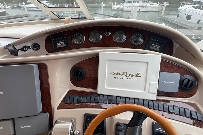 Slide: The Image of Dashboard of a 2002 Sea Ray 480 Motor Yacht with navigation equipment. - 9