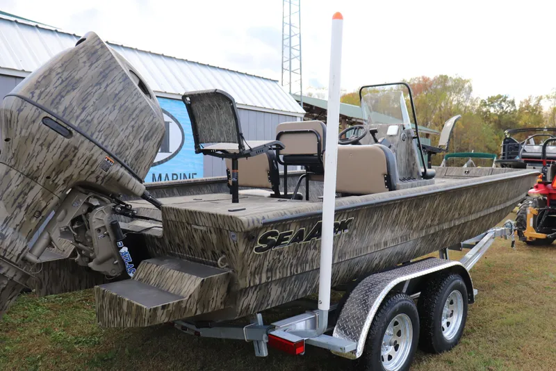 Slide: The Image of 2026 SeaArk Phantom 20XV CC boat on trailer, camo design, outdoor setting. - 8