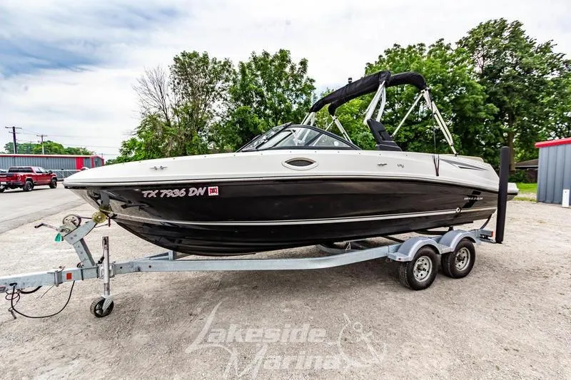 Slide: The Image of 2016 Bayliner VR6 Bowrider I/O on trailer, parked outdoors near trees. - 11