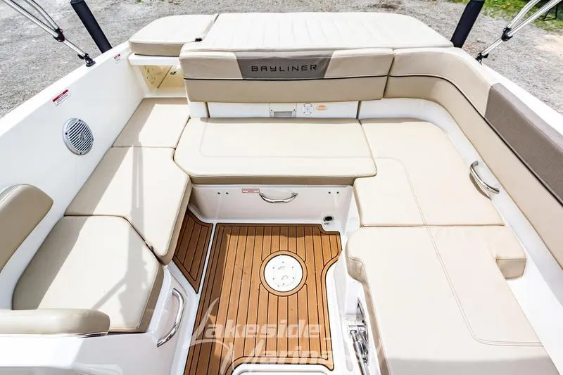 Slide: The Image of 2016 Bayliner VR6 Bowrider I/O interior with beige seating and wood-style flooring. - 12