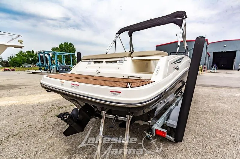 Slide: The Image of 2016 Bayliner VR6 Bowrider I/O on trailer at marina, rear view. - 16