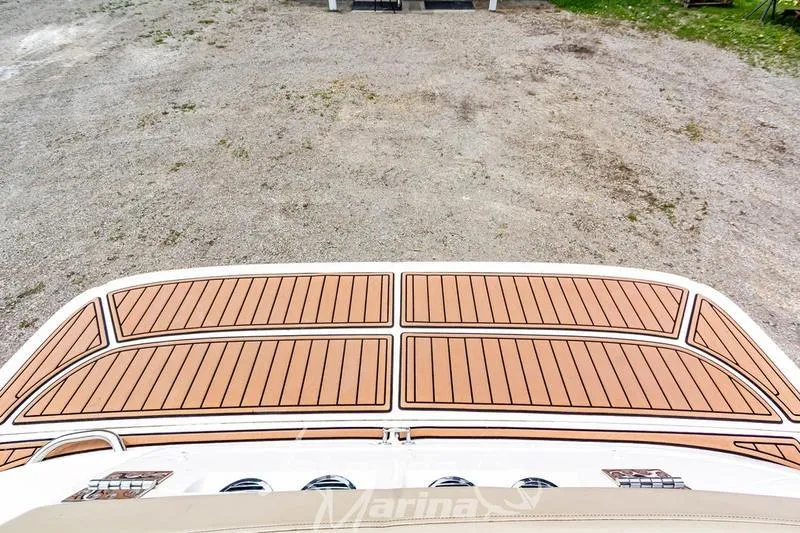 Slide: The Image of 2016 Bayliner VR6 Bowrider I/O with teak-style swim platform, parked on gravel. - 19