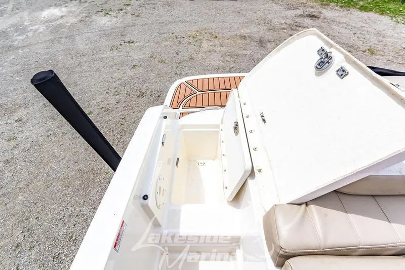 Slide: The Image of 2016 Bayliner VR6 Bowrider I/O boat with open storage compartment and cushioned seating. - 5