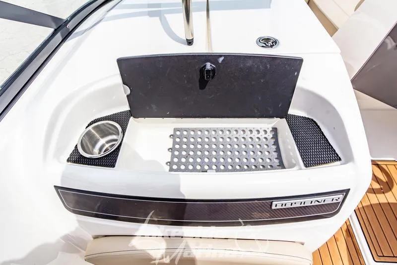 Slide: The Image of 2016 Bayliner VR6 Bowrider I/O boat interior with sink and storage area. - 9
