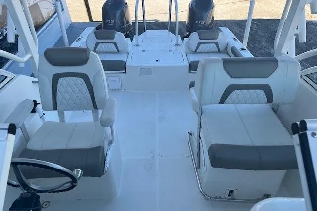 Slide: The Image of 2021 World Cat 230 DC boat interior with dual seating and twin engines. - 6