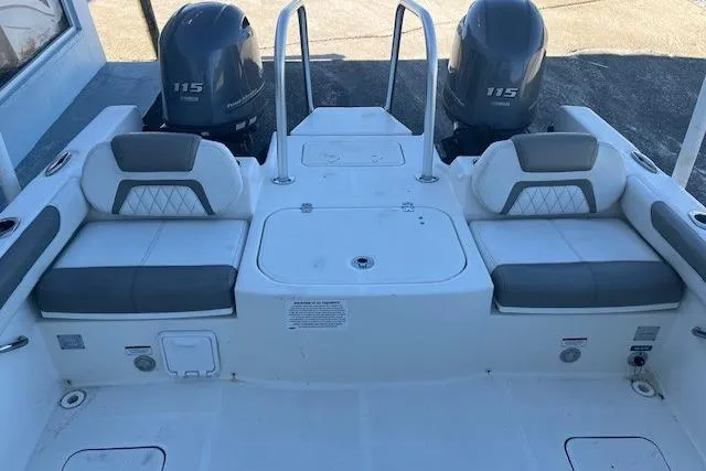 Slide: The Image of 2021 World Cat 230 DC boat interior with dual 115 engines and cushioned seating. - 7