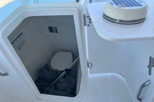Slide: The Image of 2021 World Cat 230 DC boat interior with compact marine toilet. - 8