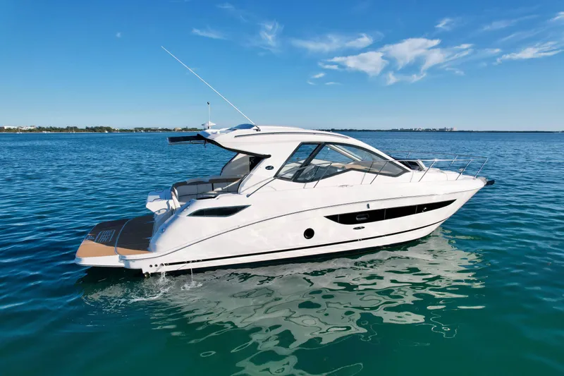 Slide: The Image of 2018 Sea Ray 350 DAC yacht cruising on clear blue water under a sunny sky. - 1