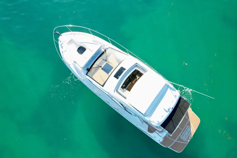 Slide: The Image of Aerial view of 2018 Sea Ray 350 DAC boat on clear turquoise water. - 11