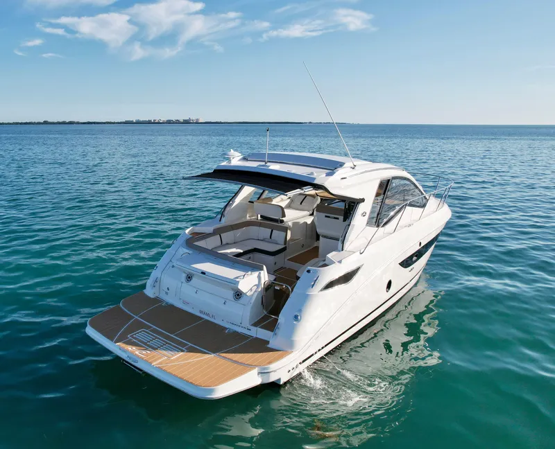 Slide: The Image of 2018 Sea Ray 350 DAC yacht cruising on open water under clear skies. - 13