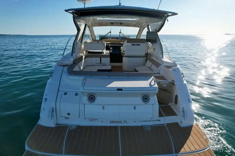 Slide: The Image of 2018 Sea Ray 350 DAC yacht on calm ocean waters, rear view. - 17