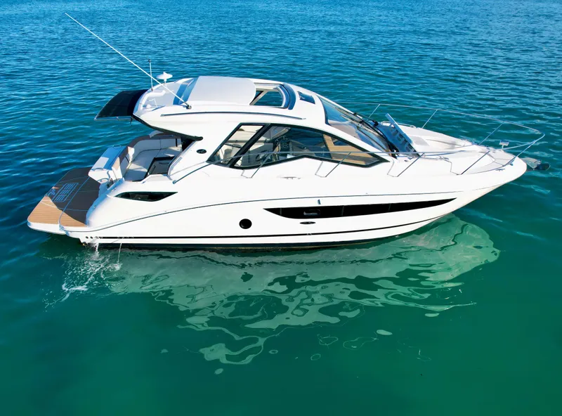 Slide: The Image of 2018 Sea Ray 350 DAC luxury yacht on clear blue water. - 2