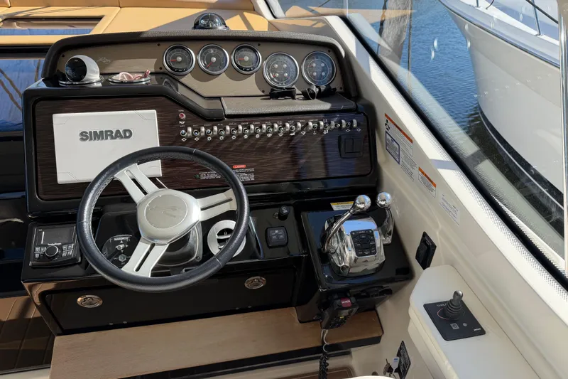 Slide: The Image of Cockpit of 2018 Sea Ray 350 Sundancer with Simrad navigation system and controls. - 20