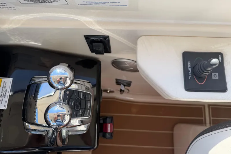 Slide: The Image of Control panel of 2018 Sea Ray 350 Sundancer boat with throttle and thruster controls. - 21