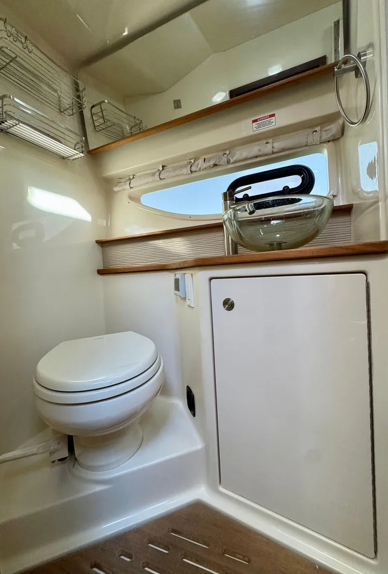 Slide: The Image of 2018 Sea Ray 350 DAC bathroom with modern fixtures and compact design. - 26