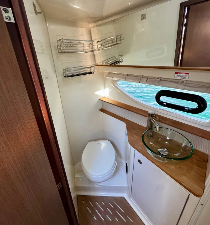 Slide: The Image of 2018 Sea Ray 350 DAC bathroom with modern fixtures and wood accents. - 27