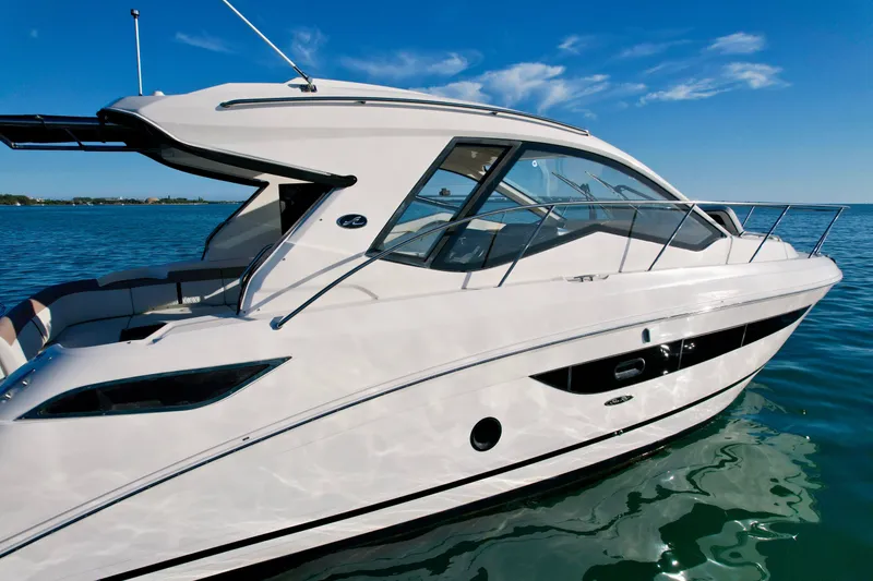 Slide: The Image of 2018 Sea Ray 350 DAC yacht on calm water under clear blue sky. - 3