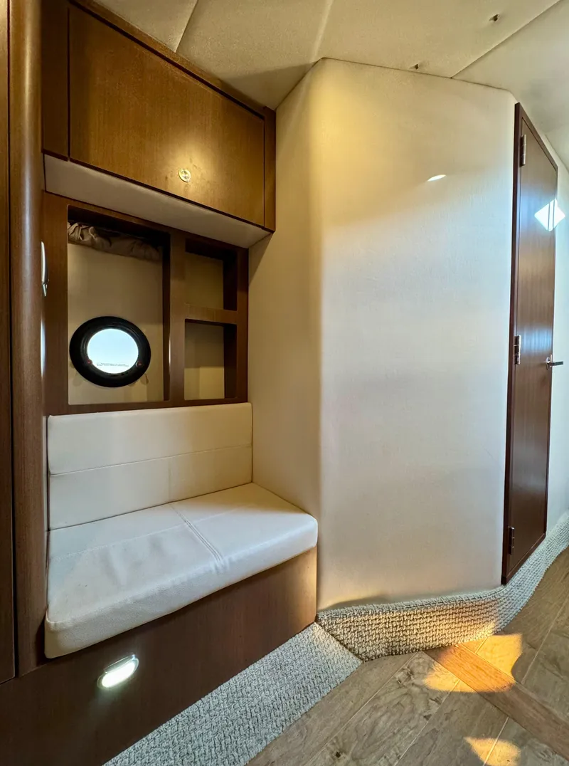 Slide: The Image of Interior of 2018 Sea Ray 350 DAC yacht with cozy seating and porthole window. - 31