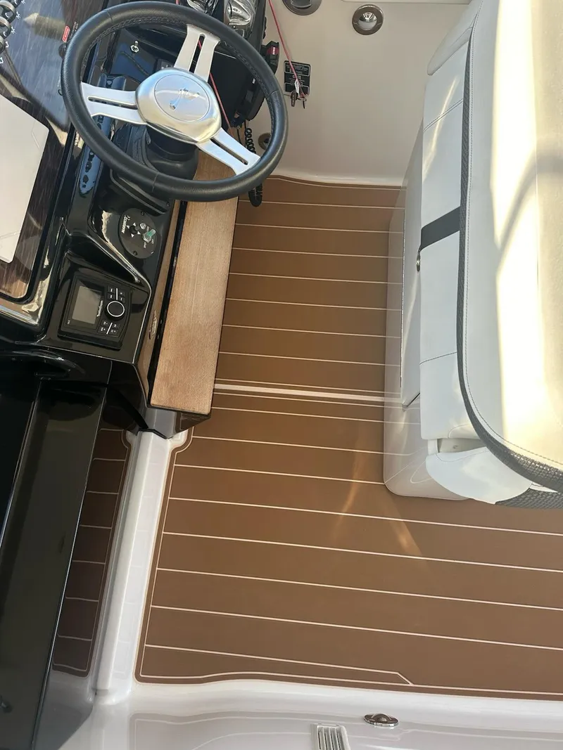 Slide: The Image of 2018 Sea Ray 350 DAC boat interior with steering wheel and seating area. - 40
